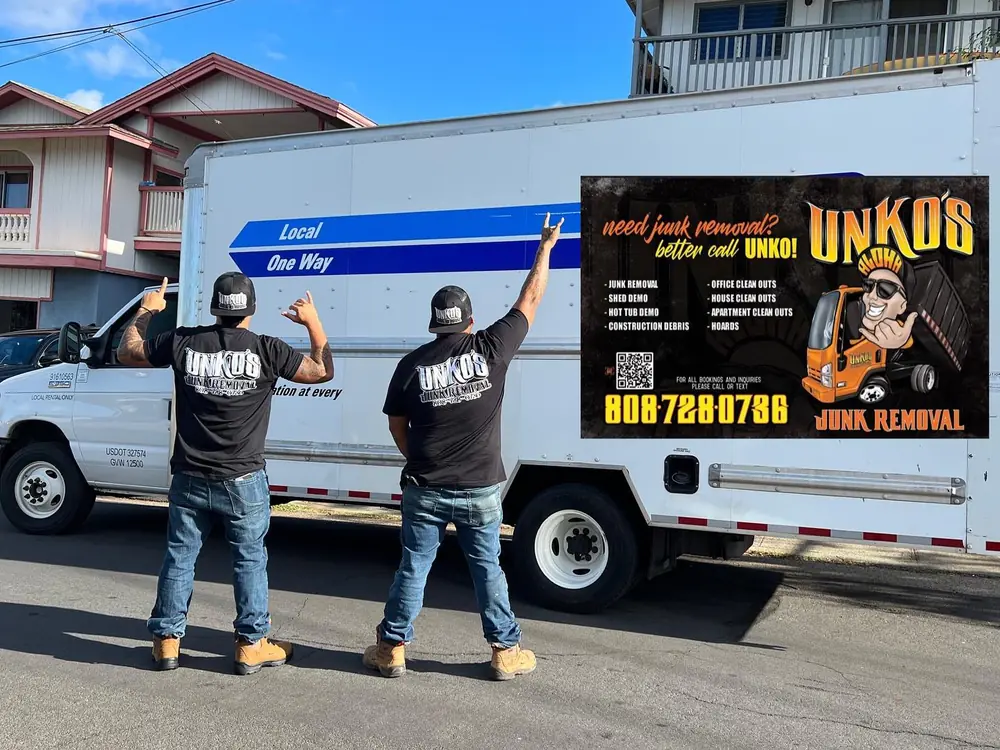 Cu and Cedric standing beside a rental box truck with the Unko's sign mounted on its side, arms raised.